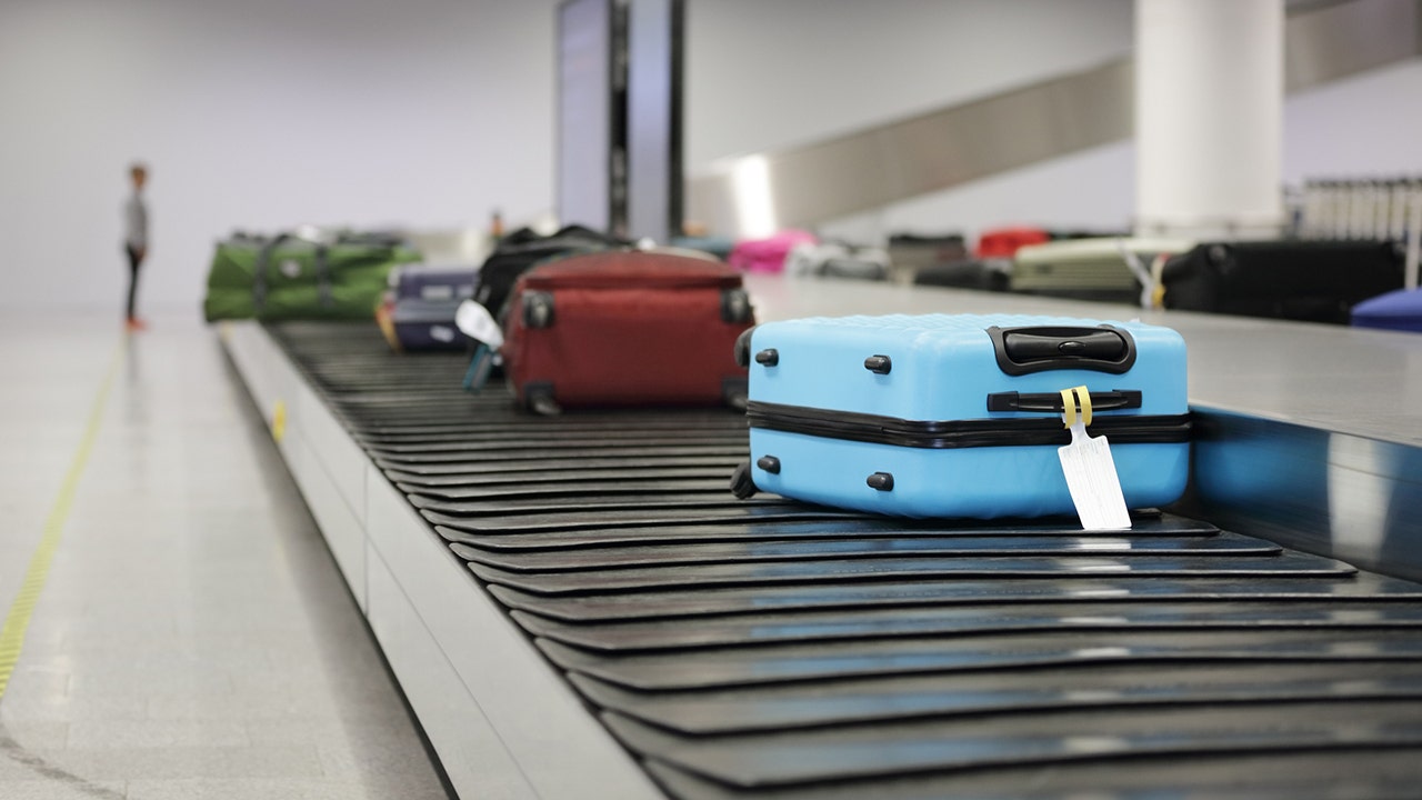 Luggage On Conveyor Belt With Tag.jpg